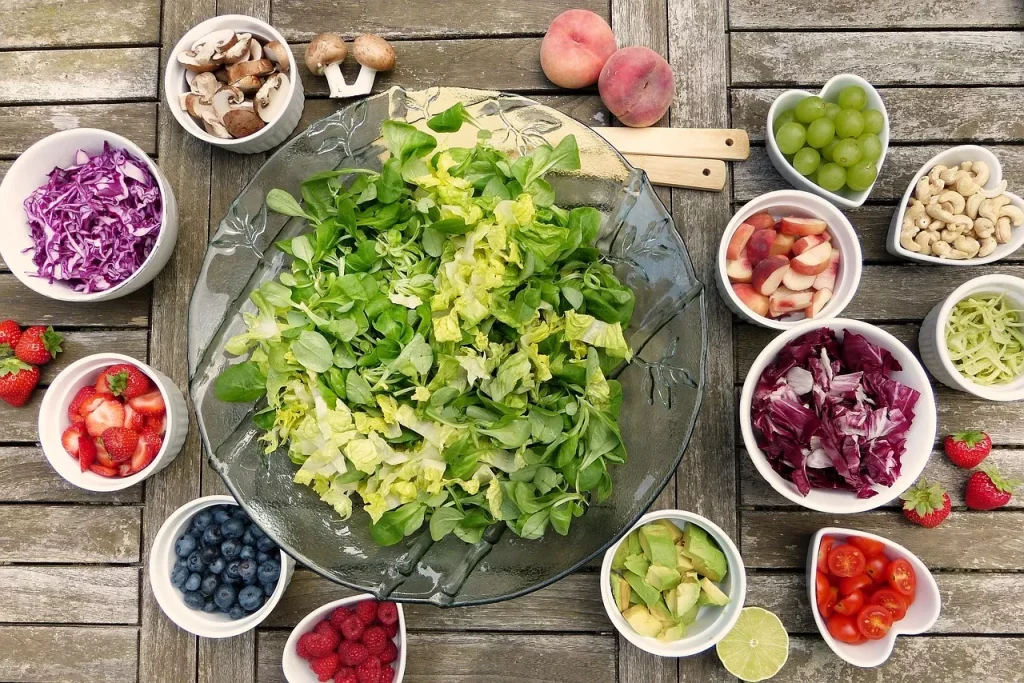 a colorful green salad surrounded by toppings